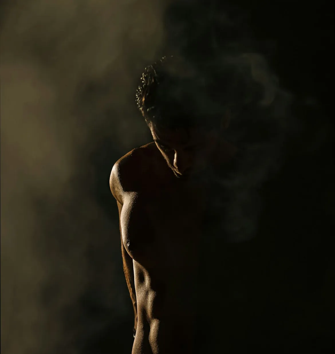 Athlete in side light, torso in shadow